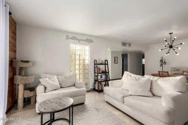 a living room with furniture and a chandelier