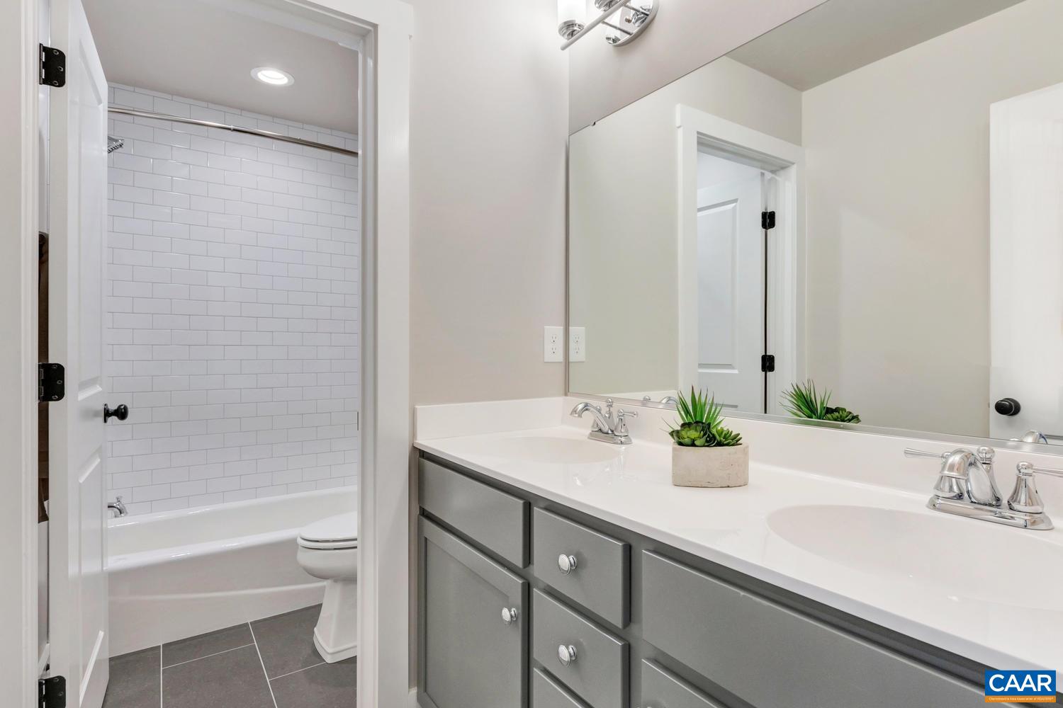 1140 Riparian Court Charlottesville, VA 22911 - Photo 39 of 57 a bathroom with a bathtub shower sink vanity and toilet
