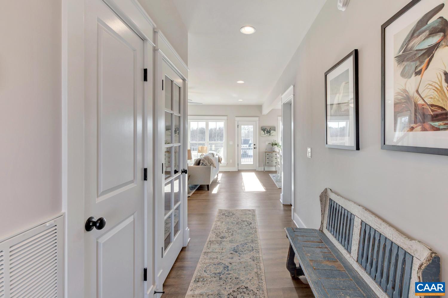 1140 Riparian Court Charlottesville, VA 22911 - Photo 6 of 57 a view of a hallway with wooden floor and a bathroom