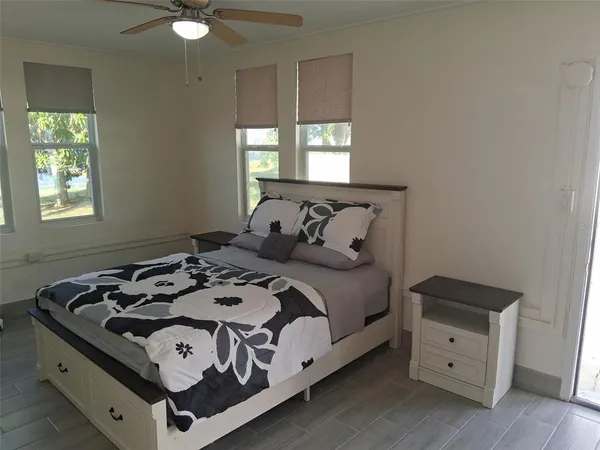 a bedroom with a bed and a window