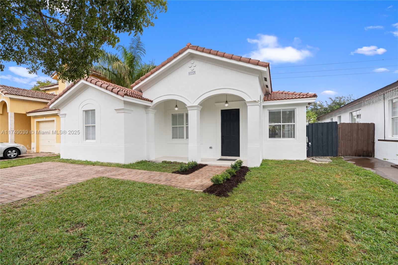 10721 Southwest 240th Terrace Homestead, FL 33032 - Photo 1 of 1 a front view of a house with a garden