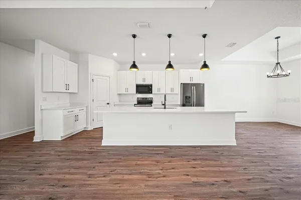 a view of a livingroom with a hardwood floor and a ceiling fan