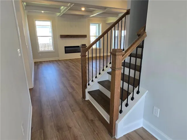 a view of entryway and hall with wooden floor