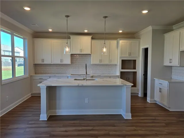 a view of kitchen with granite countertop counter space a sink appliances and cabinets