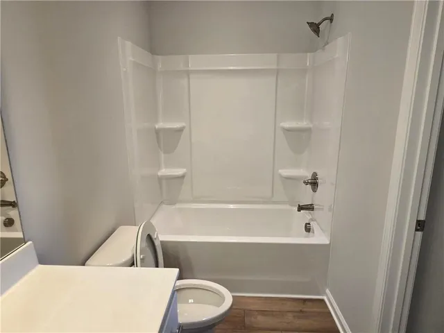 a bathroom with a bathtub and toilet