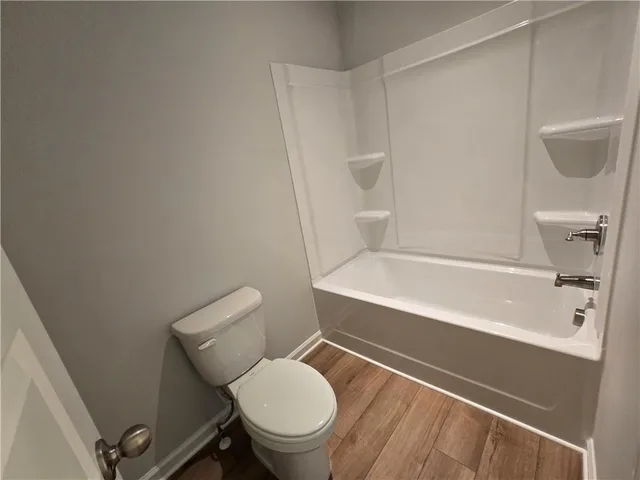 a bathroom with a toilet and a bathtub