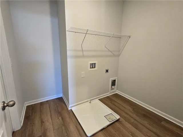 a view of a room with wooden floor