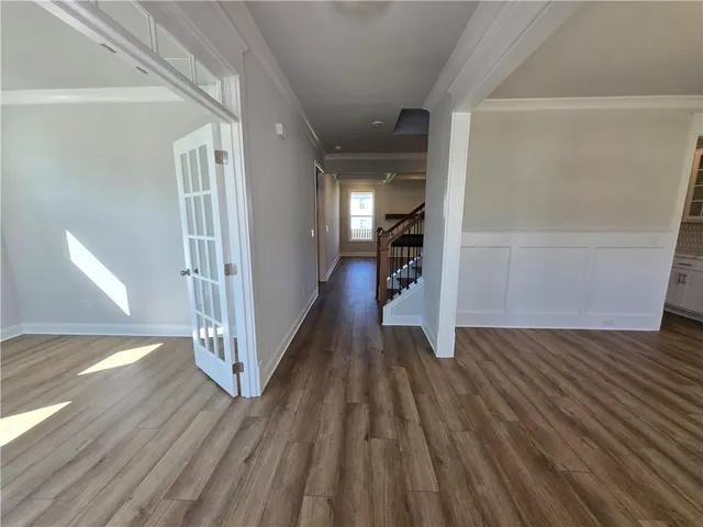 a view of a hallway view with wooden floor and staircase