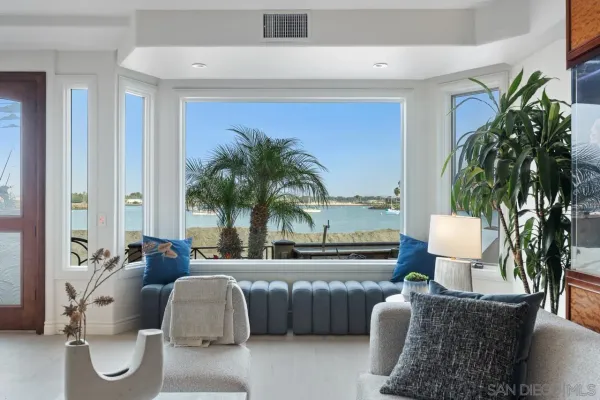 a living room with stainless steel appliances granite countertop furniture and fireplace