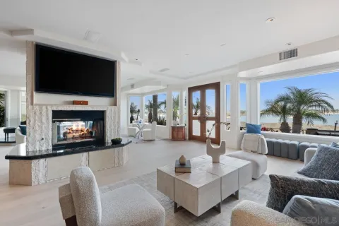 a room with stainless steel appliances kitchen island granite countertop furniture and a large window