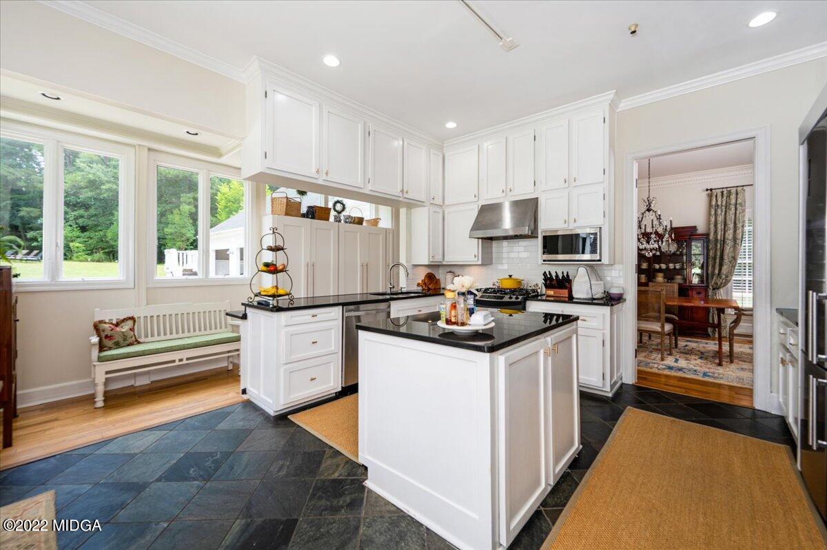 788 Bass Road Macon, GA 31210 - Photo 20 of 71 a kitchen with white cabinets and appliances