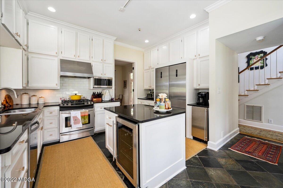 788 Bass Road Macon, GA 31210 - Photo 24 of 71 a kitchen with stainless steel appliances granite countertop a stove top oven a sink a refrigerator and white cabinets