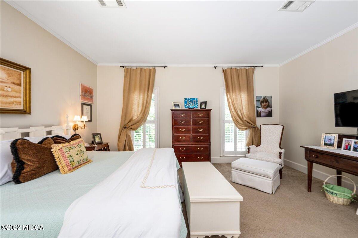 788 Bass Road Macon, GA 31210 - Photo 31 of 71 a bedroom with furniture a flat screen tv and a couch