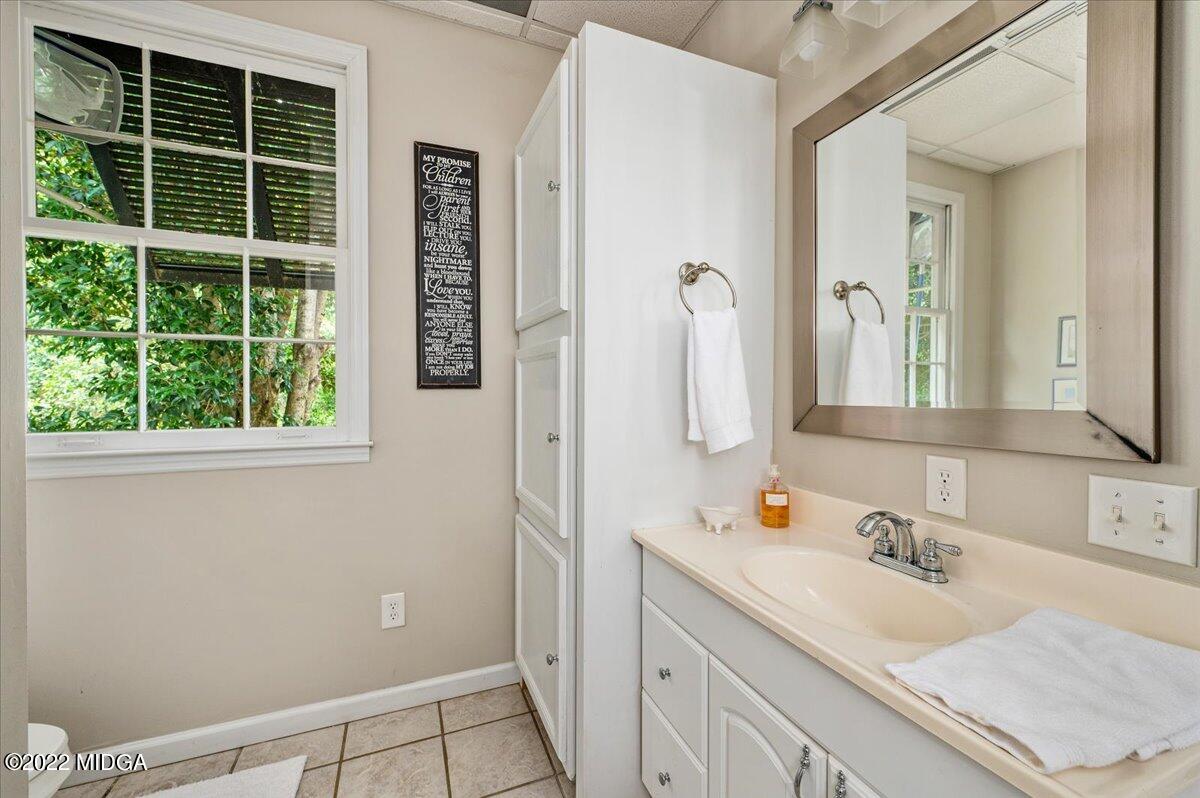 788 Bass Road Macon, GA 31210 - Photo 53 of 71 a bathroom with a granite countertop sink and a mirror