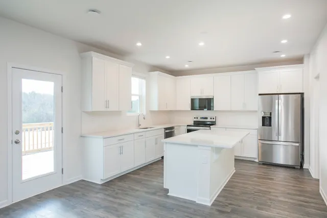 a view of a kitchen with cabinets and wooden floor