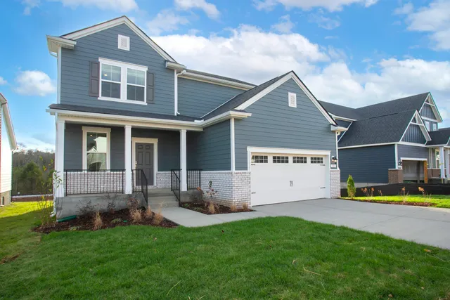 a front view of house with yard and green space