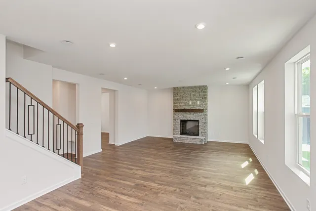 a view of a kitchen with furniture and wooden floor