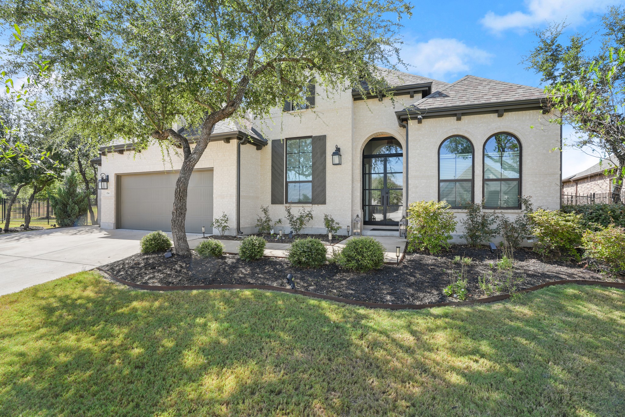 154 LITTLE Strm Cove Austin, TX 78737 - Photo 36 of 37 Stately stone masonry and arched windows define this striking multi-level facade.