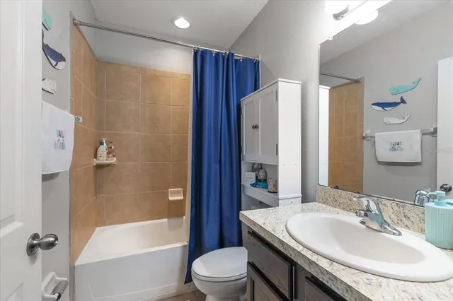 a bathroom with a sink toilet tub and shower