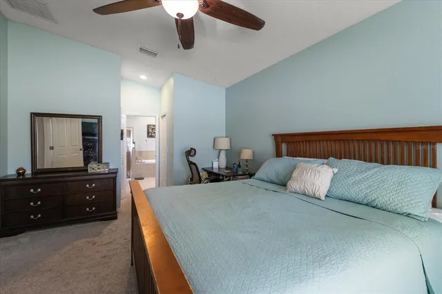 a bathroom with a bathtub double vanity sink and a large mirror