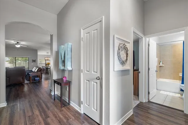 a very nice looking room with wooden floor and a bathroom