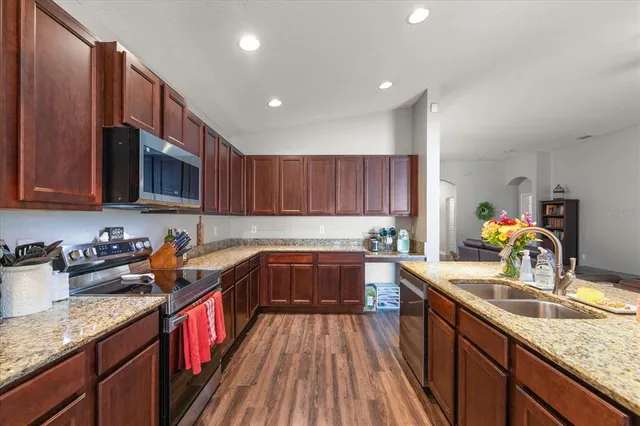 a kitchen with a sink a stove and cabinets