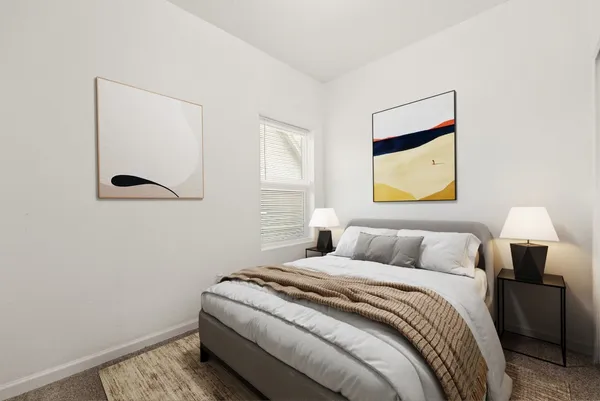 a bedroom with a bed and a painting on the wall