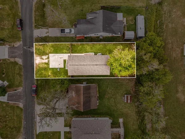 an aerial view of a houses with a yard