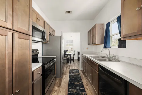 a kitchen with a sink and refrigerator