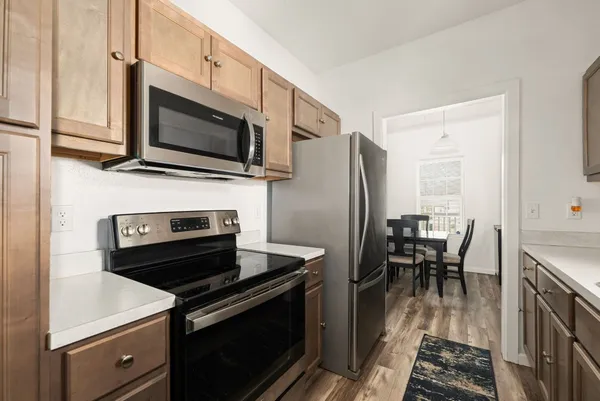 a kitchen with a stove microwave and a dining table