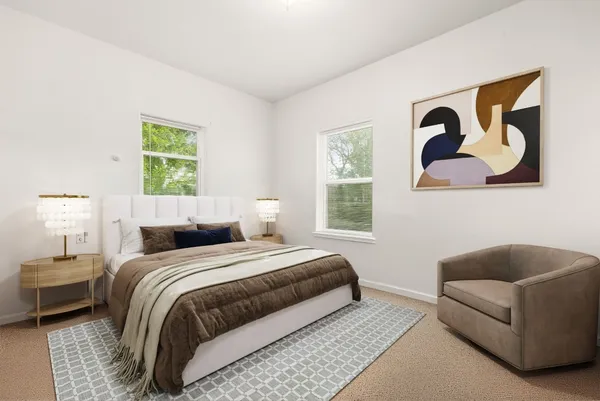 a bedroom with a bed couch and a window