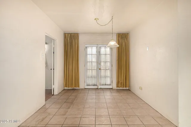 a view of an empty room with glass door