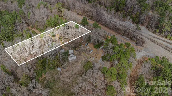 a view of a yard with wooden fence
