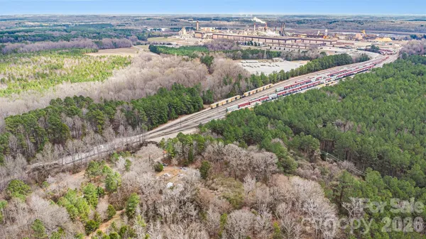 an aerial view of residential houses with outdoor space and river