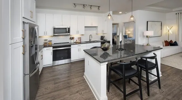 a kitchen with kitchen island a sink stove and refrigerator