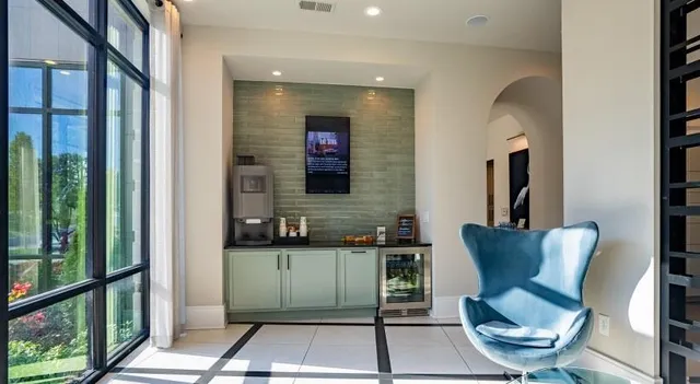 a living room with furniture tv and large windows