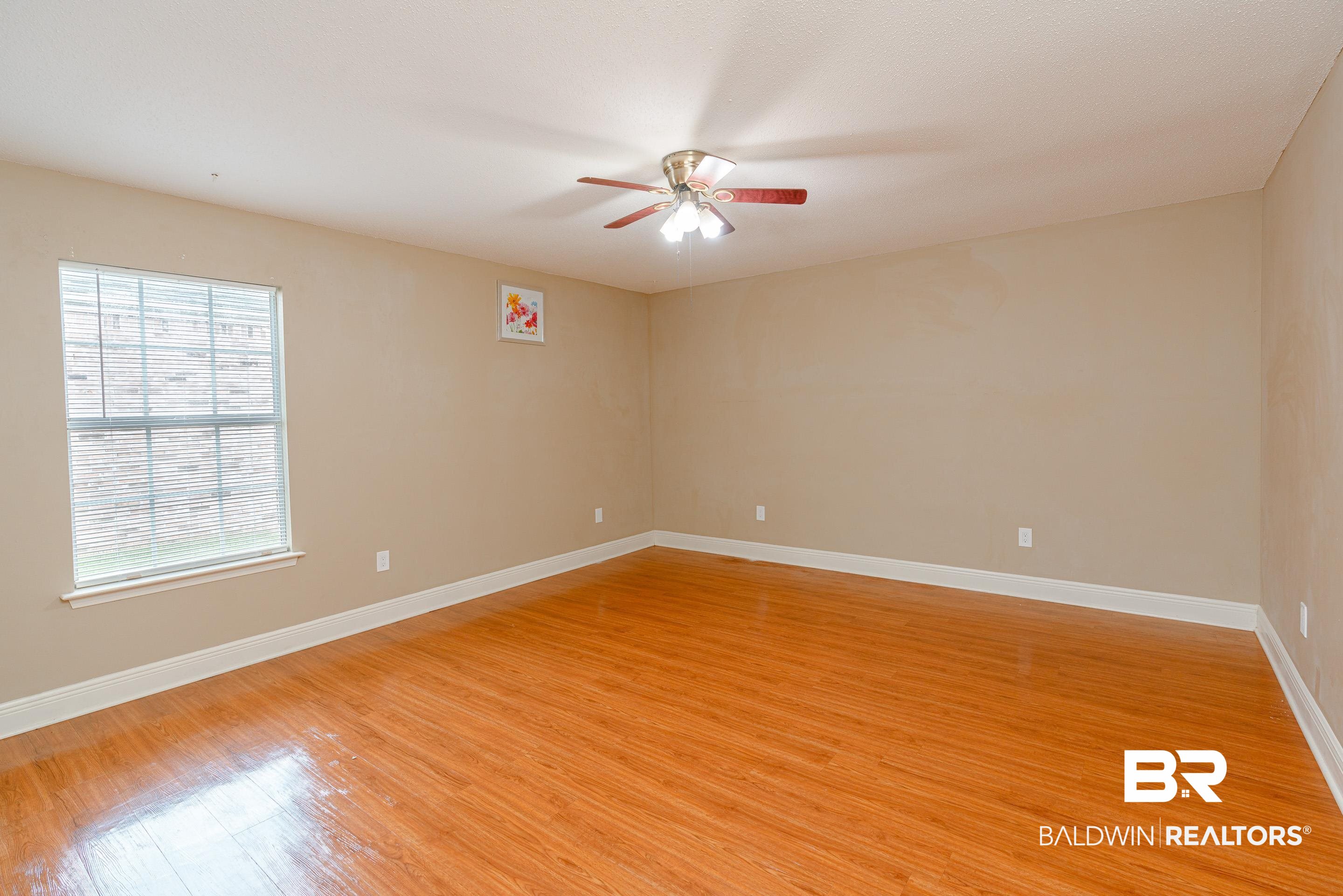23 Old Mill Court Mobile, AL 36608 - Photo 24 of 37 Unfurnished room featuring a healthy amount of sunlight, light wood-type flooring, and ceiling fan