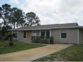 120 Southwest Ware Palm Bay, FL 32908 - Photo 11 of 11 front view of a house with a yard