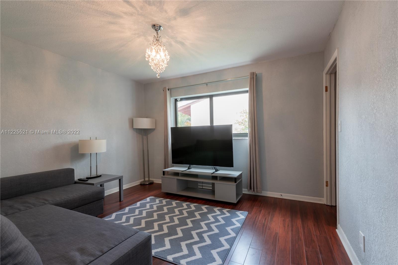 3453 Spring Bluff Place, Unit 12 Lauderhill, FL 33319 - Photo 14 of 20 a living room with furniture and a flat screen tv