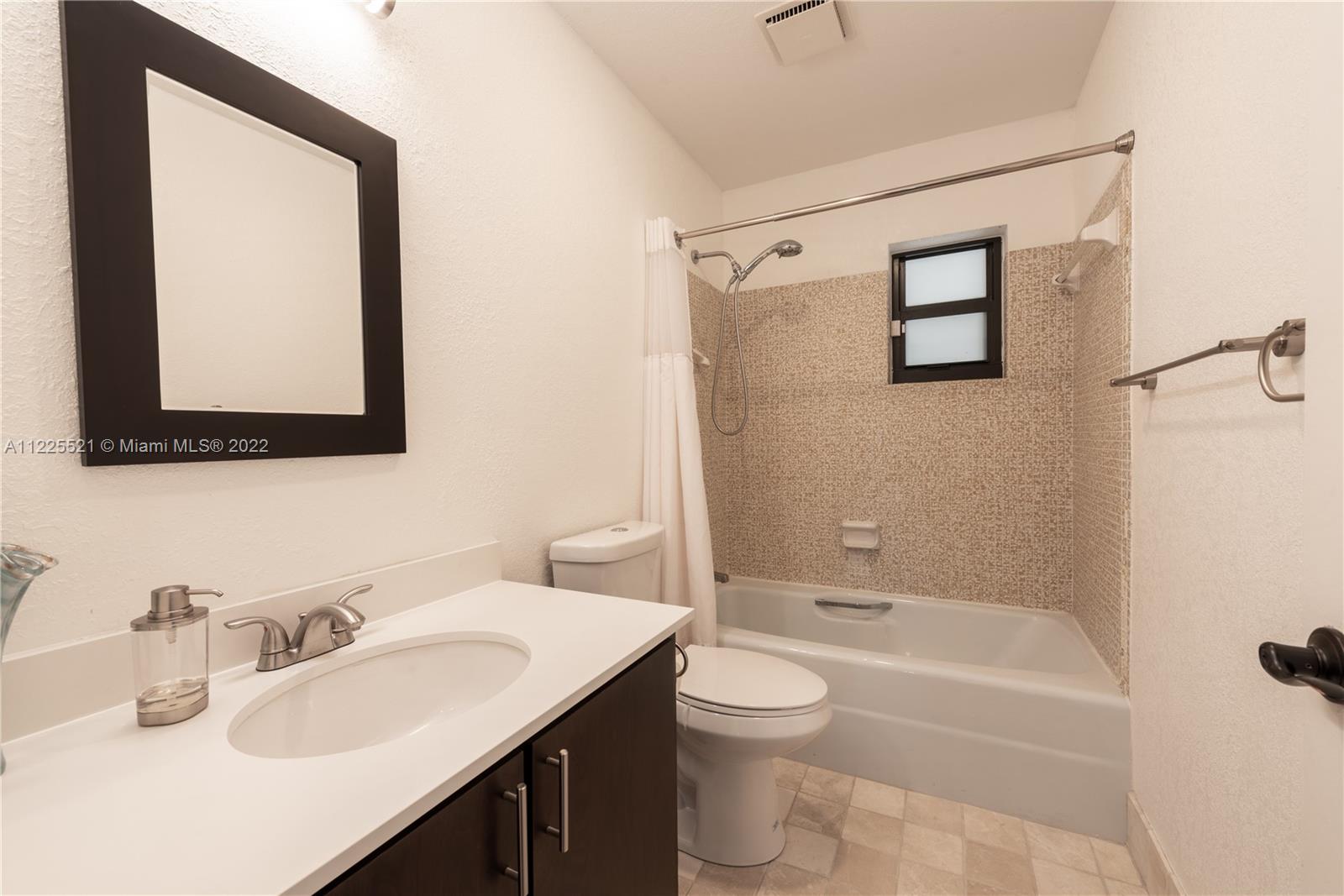 3453 Spring Bluff Place, Unit 12 Lauderhill, FL 33319 - Photo 15 of 20 a bathroom with a sink toilet and shower