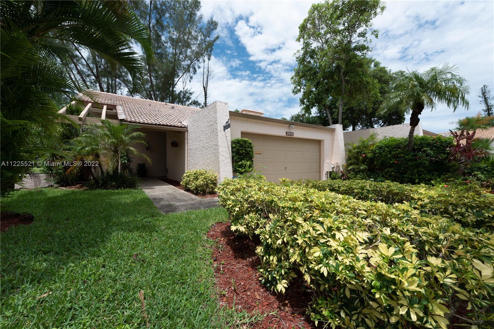 3453 Spring Bluff Place, Unit 12 Lauderhill, FL 33319 - Photo 16 of 20 a view of a house with a garden