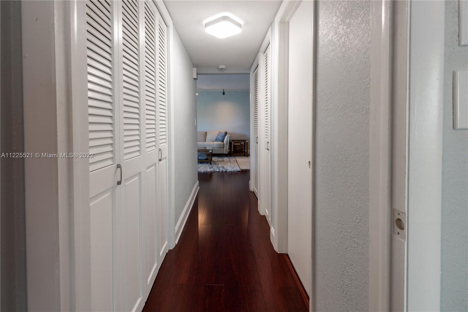 3453 Spring Bluff Place, Unit 12 Lauderhill, FL 33319 - Photo 8 of 20 a view of a hallway with a wooden floor