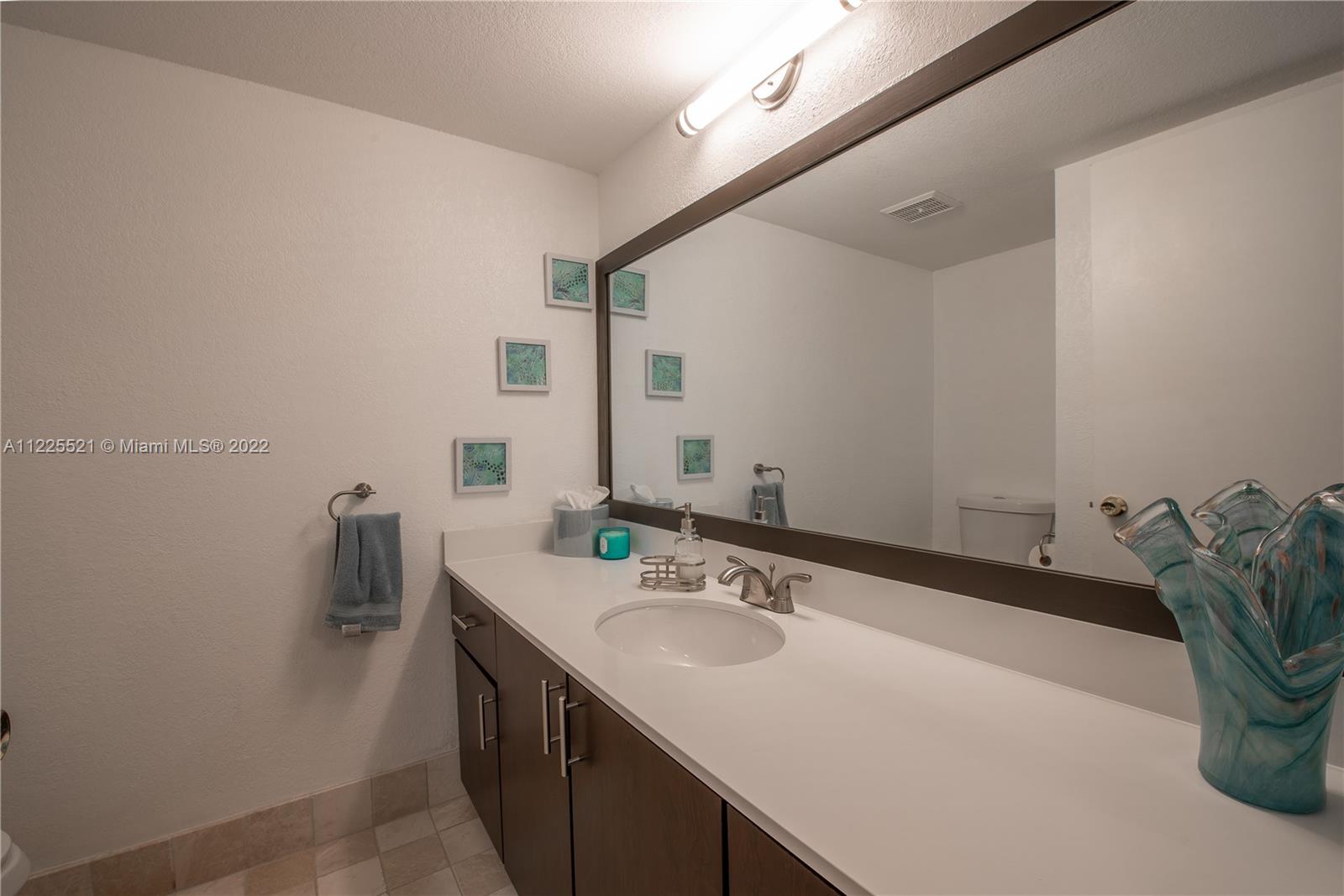 3453 Spring Bluff Place, Unit 12 Lauderhill, FL 33319 - Photo 9 of 20 a bathroom with a sink and a mirror