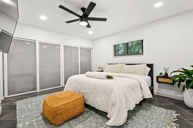 a bedroom with a bed and a chandelier