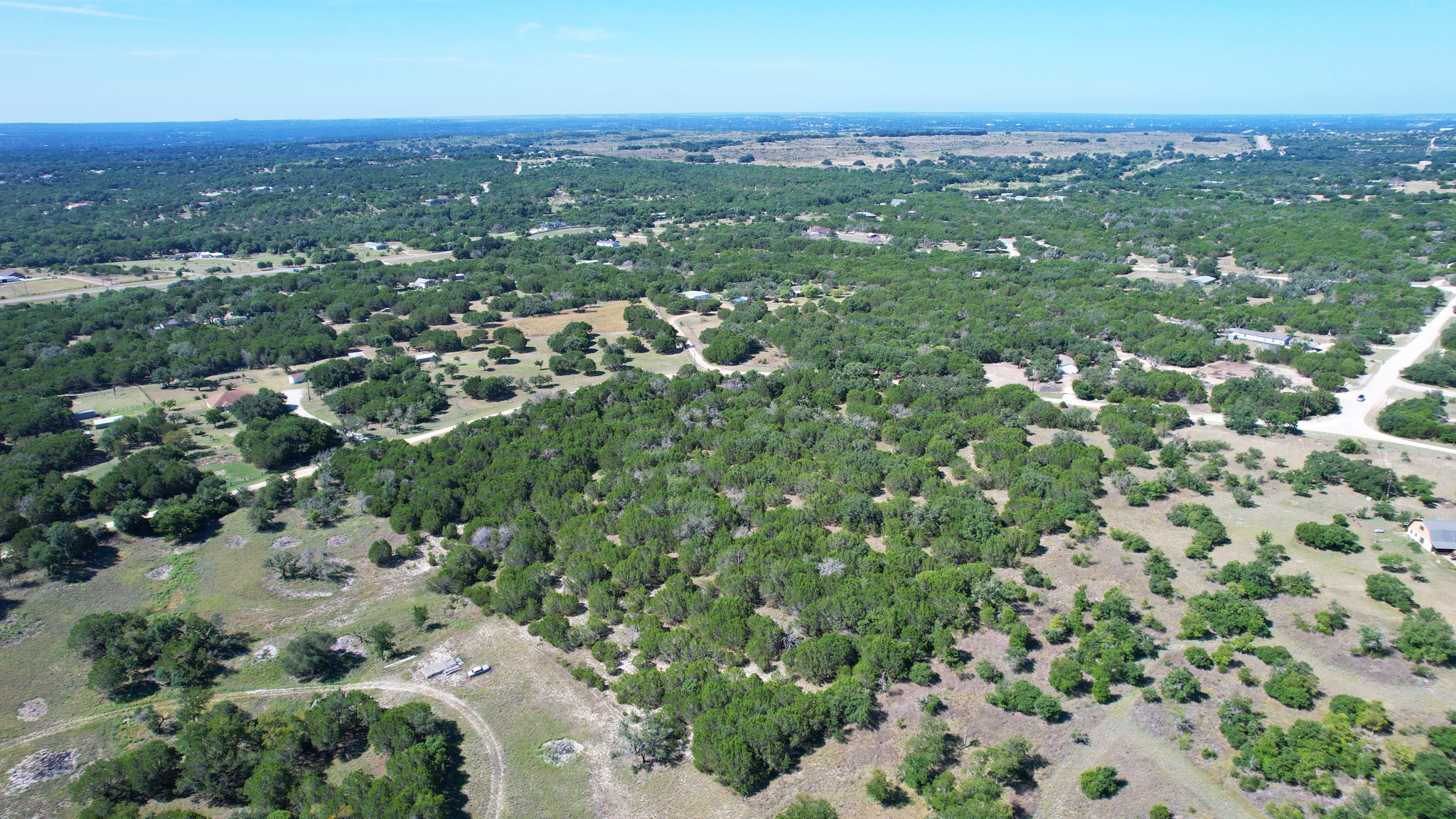 167 Private Road 3442 Road South Kempner, TX 76539 - Photo 4 of 7 A sweeping aerial perspective reveals a vast, tree-filled landscape dotted with distant residential properties.