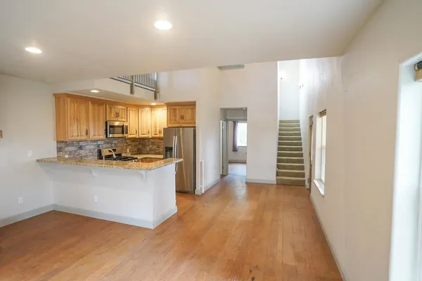 a kitchen with stainless steel appliances a refrigerator and a stove top oven