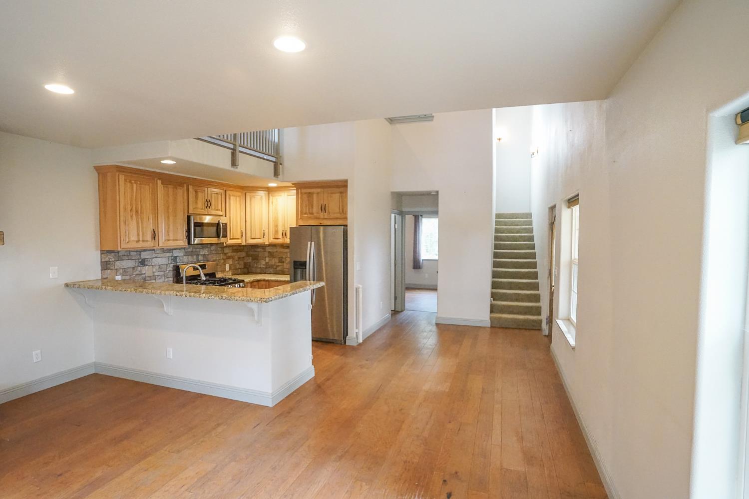 16375 Jesus Maria Road Mokelumne Hill, CA 95245 - Photo 11 of 39 a kitchen with stainless steel appliances a refrigerator and a stove top oven