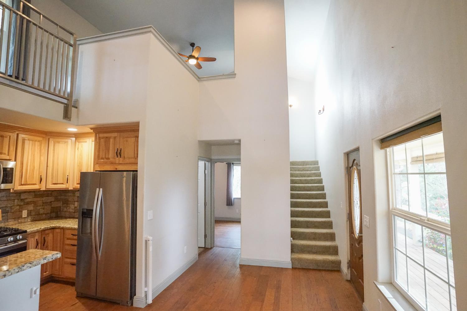 16375 Jesus Maria Road Mokelumne Hill, CA 95245 - Photo 15 of 39 a view of a kitchen with a refrigerator cabinets and wooden floor
