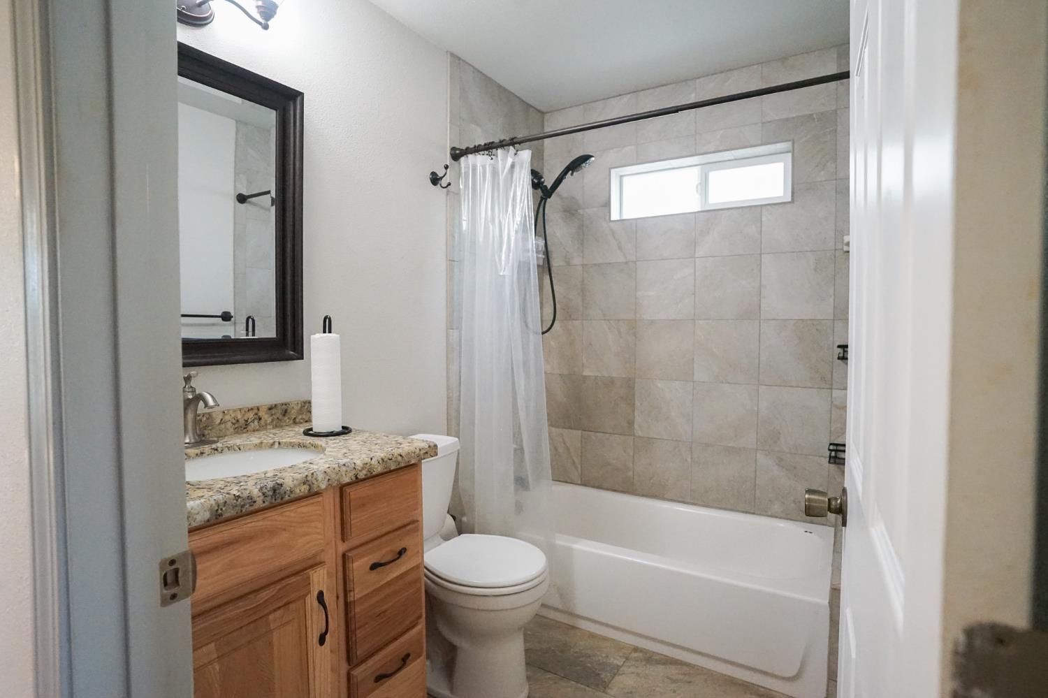 16375 Jesus Maria Road Mokelumne Hill, CA 95245 - Photo 16 of 39 a bathroom with a granite countertop toilet sink and shower