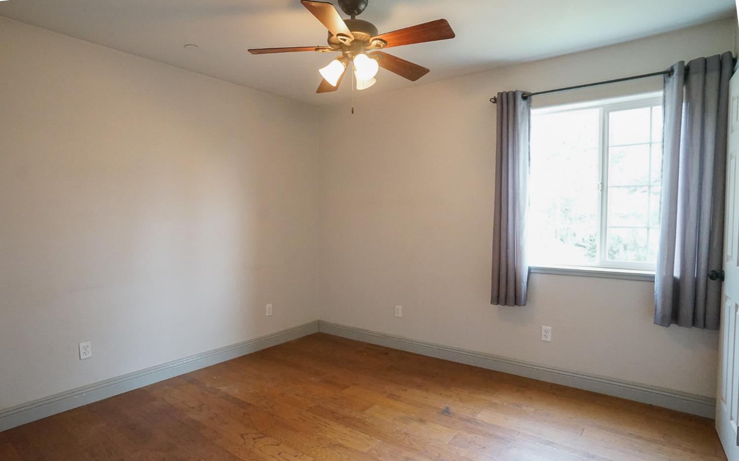 16375 Jesus Maria Road Mokelumne Hill, CA 95245 - Photo 17 of 39 an empty room with a window and a fan